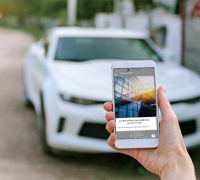 smartphone-woman-hand-background-white-car.jpg